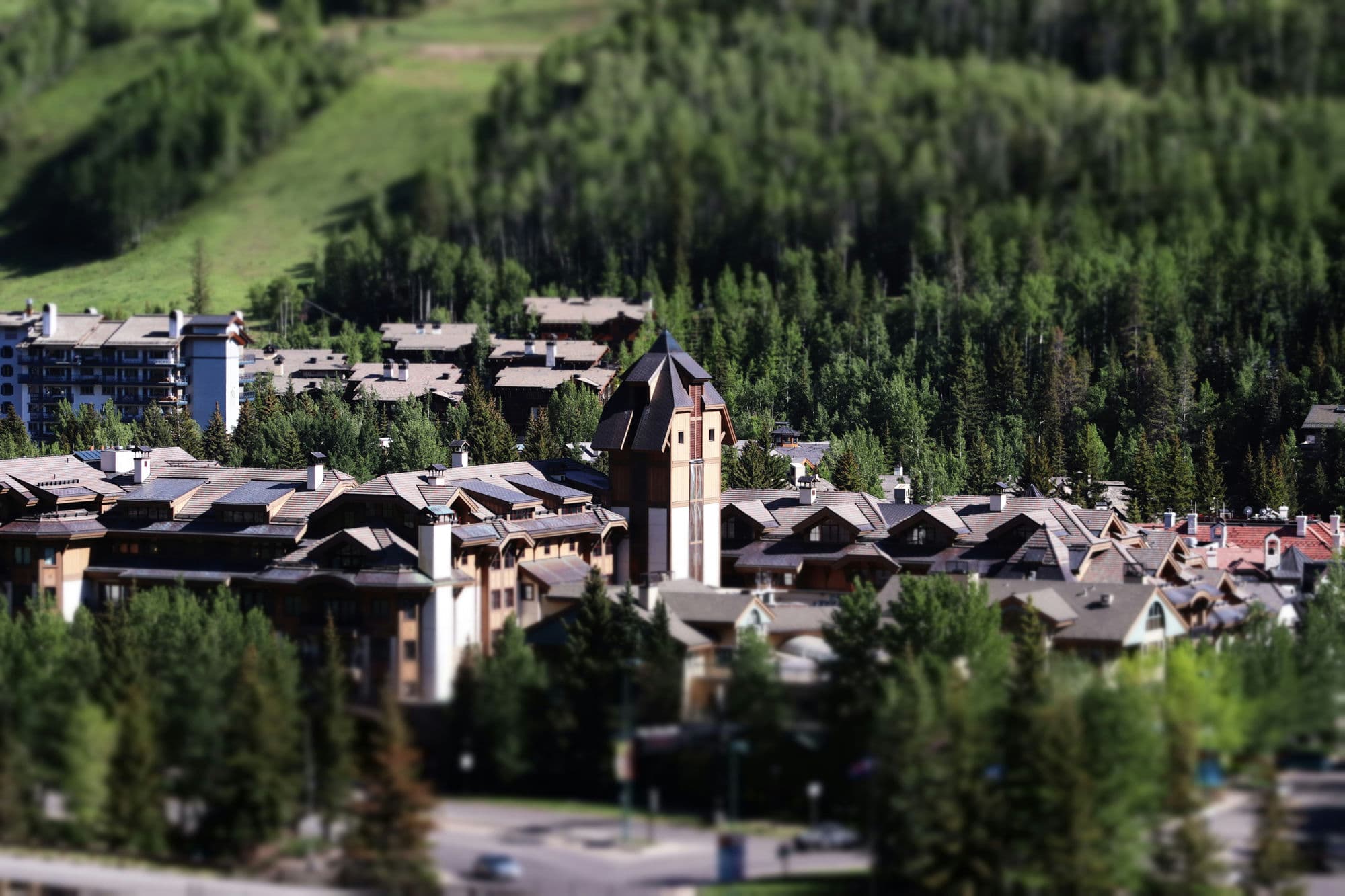 Tilt-shift aerial view of Vail Village surrounded by summer forest