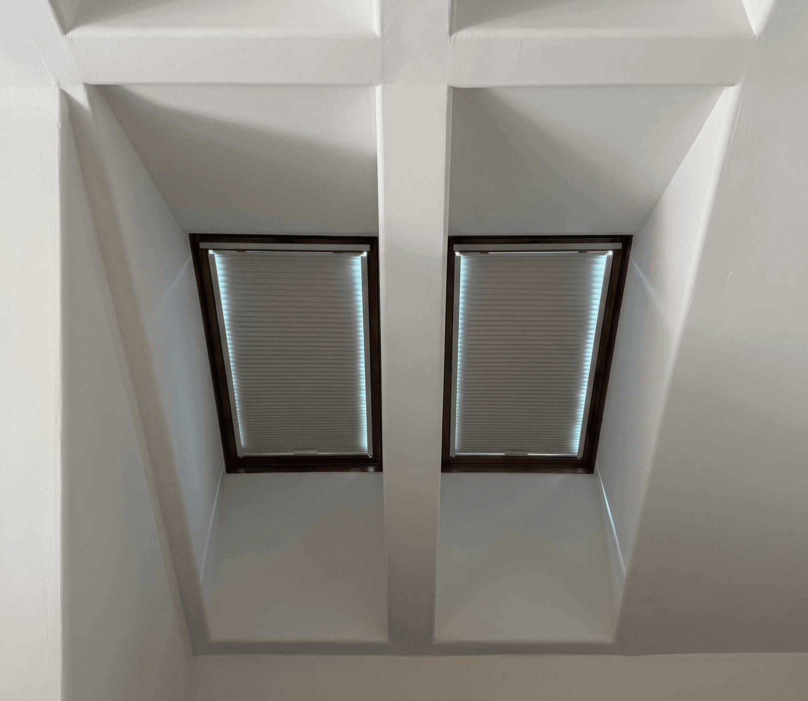 Custom cellular shades fitted to angled skylight windows