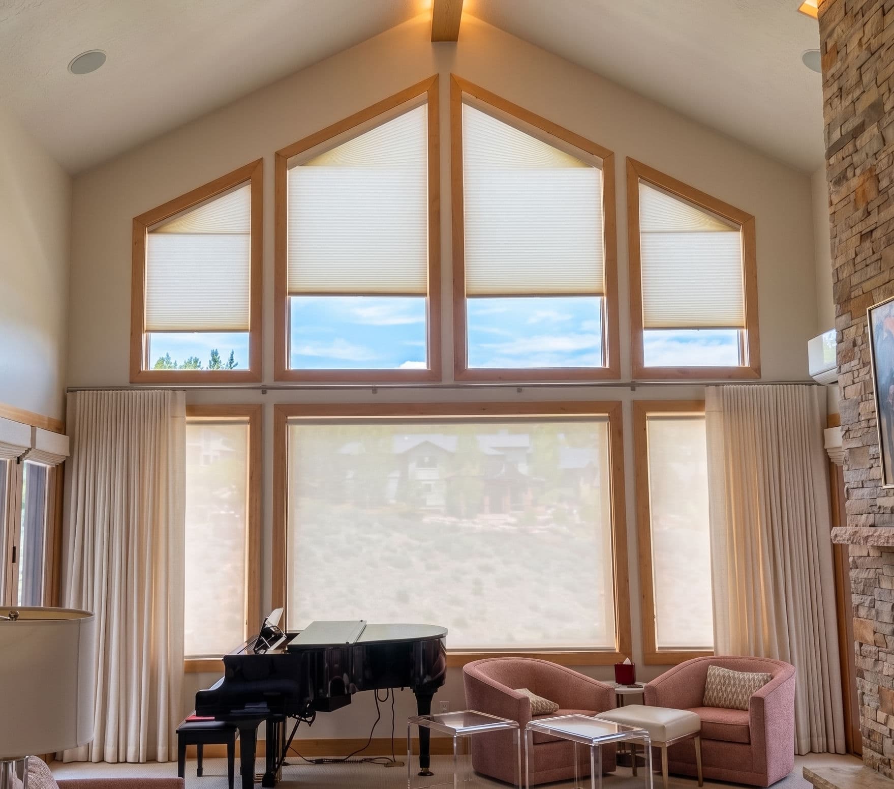 Custom motorized shades and draperies in a mountain home living room